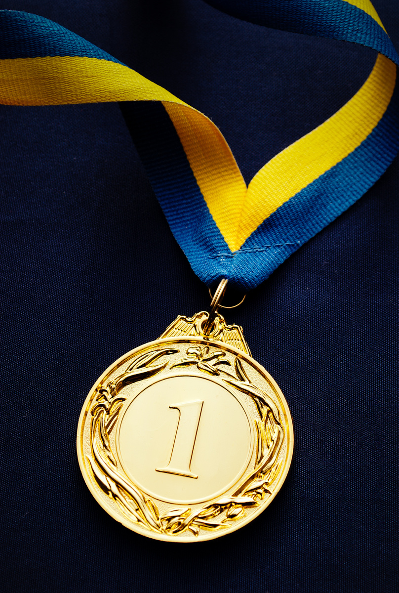 Gold medal on a dark blue background